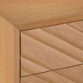 Close-up showing full chamfered profile edge and diagonal grain pattern on drawer fronts