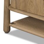 Close-up of tightly woven paper cord shelf resting within the smoked oak wood frame base