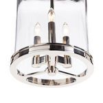 Close-up view showing the polished nickel metal ring base and three lit candle-style bulbs inside glass lantern