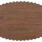 Top view of oval table surface featuring notched gear-like edge detail in natural wood