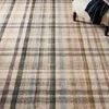 Close-up of the rug’s plaid pattern showing the blend of ivory, blue, green, and brown tones