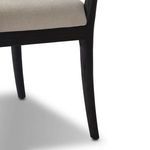 Close-up showing curved rear leg design and wood grain on Tova Dining Armchair