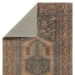 Back side of the rug showing its non-slip underside and folded corner