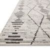 Angled view highlighting low pile and edge of charcoal and dove patterned transitional rug