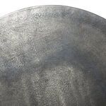 Macro shot of tabletop surface capturing metallic granularity and variegated antique finish