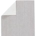 Backside of rug showing solid white underside contrasted with light gray top