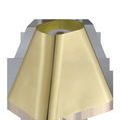 Close-up from above showing the lamp’s open-top trapezoidal brass shade with a smooth reflective finish