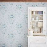 Rachel Ashwell Garden Floral wallpaper applied in room setting with white distressed cabinet and floral arrangement