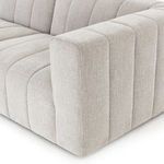 Detailed close-up of sectional arm and seat showing deep channel stitching and soft fabric texture