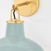 Close-up of Pottersville Wall Sconce ceramic shade texture and gold arm attachment with black cord