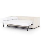 Sofa bed fully unfolded into a full-size bed with mattress and pillow
