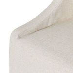 Close-up of cushioned seat and armrest seam showcasing fine gray woven upholstery