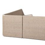 Detailed side view showing rattan weave and cushioned bench arching slightly at seat