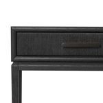 Close-up of woven paper cord drawer front with matte dark metal handle