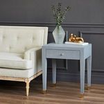 Claudette Side Table styled next to beige tufted sofa in dark room setting