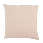 reverse side of pillow with sewn label on corner and fringe edges visible