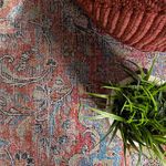 Corner rug detail showing soft colors and intricate floral medallion underfoot