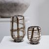 Two vases displayed on a white pedestal with textured gray stone sculpture in background