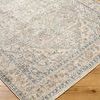 Close-up corner view showing detailed medallion and border pattern on textured machine woven surface