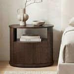 Bedroom setting with Tommy nightstand styled next to bed, holding books and decorative vases
