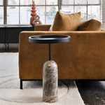 Saul End Table styled in a living room next to a mustard sofa on a light textured rug with window background