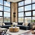 Angled view of sectional in urban loft setting with large windows and warm natural light