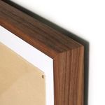 Close-up of smooth walnut frame corner and canvas edge with metal tacks