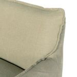 Close-up of top corner of chair backrest showing subtle slipcover stitching detail