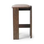Side view focusing on stool’s oak legs and frame