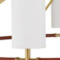 Close-up detail showing fabric texture on a linen shade and gold fittings on the leather-wrapped ring