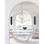 Two Flute Sconces mounted on white walls flanking a modern living room with a gold geometric chandelier