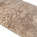 Detailed view of the plush cream shearling fabric on bench seating surface
