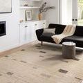 Close-up view of rug's surface texture and edge atop medium wood floor