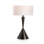 Table lamp lit to reveal the warm glow of the white drum shade