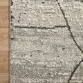 Close-up of Fabian Grey Charcoal Rug corner on wooden floor highlighting looped pile detail