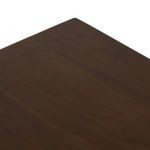 Close-up of bottom plinth base with wood grain and joint details in dark walnut veneer