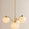 Kristen chandelier displayed hanging in a softly lit room against a beige wall