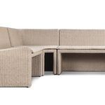 Angled close-up of tufted beige fabric cushion upholstery on the banquette