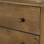 Detailed view of round knob and front edge joinery on dresser drawer