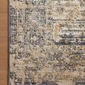Close-up showing the rug’s varying pile heights and subtle texture detail against wood flooring