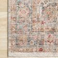 Close-up of corner section highlighting intricate border patterns and rug’s finished fringe on light wood floor