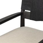 Close-up of armrest and upper side frame of the Tova Dining Armchair with visible wood texture