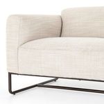 Side view focusing on sofa arm curve and sturdy wood frame beneath upholstery