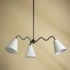 Onda chandelier hanging against beige wall with shades angled outward