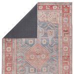 Backside of rug flipped to reveal solid dark gray backing contrasting front pattern