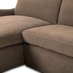 Close-up of cushion and slipcover seam detail at sectional corner between chaise and sofa