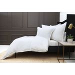 Waverly Duvet Set styled on bed in room with dark paneled wall and side table