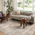 Heidi Sage / Multi Rug styled in living room with light sofa, wooden chair, and soft natural light