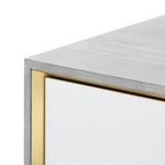 Close-up of cabinet corner highlighting wood grain texture and gold trim