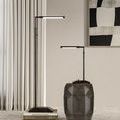 Lamp shown standing beside taller floor lamp on geometric dark wood accent piece